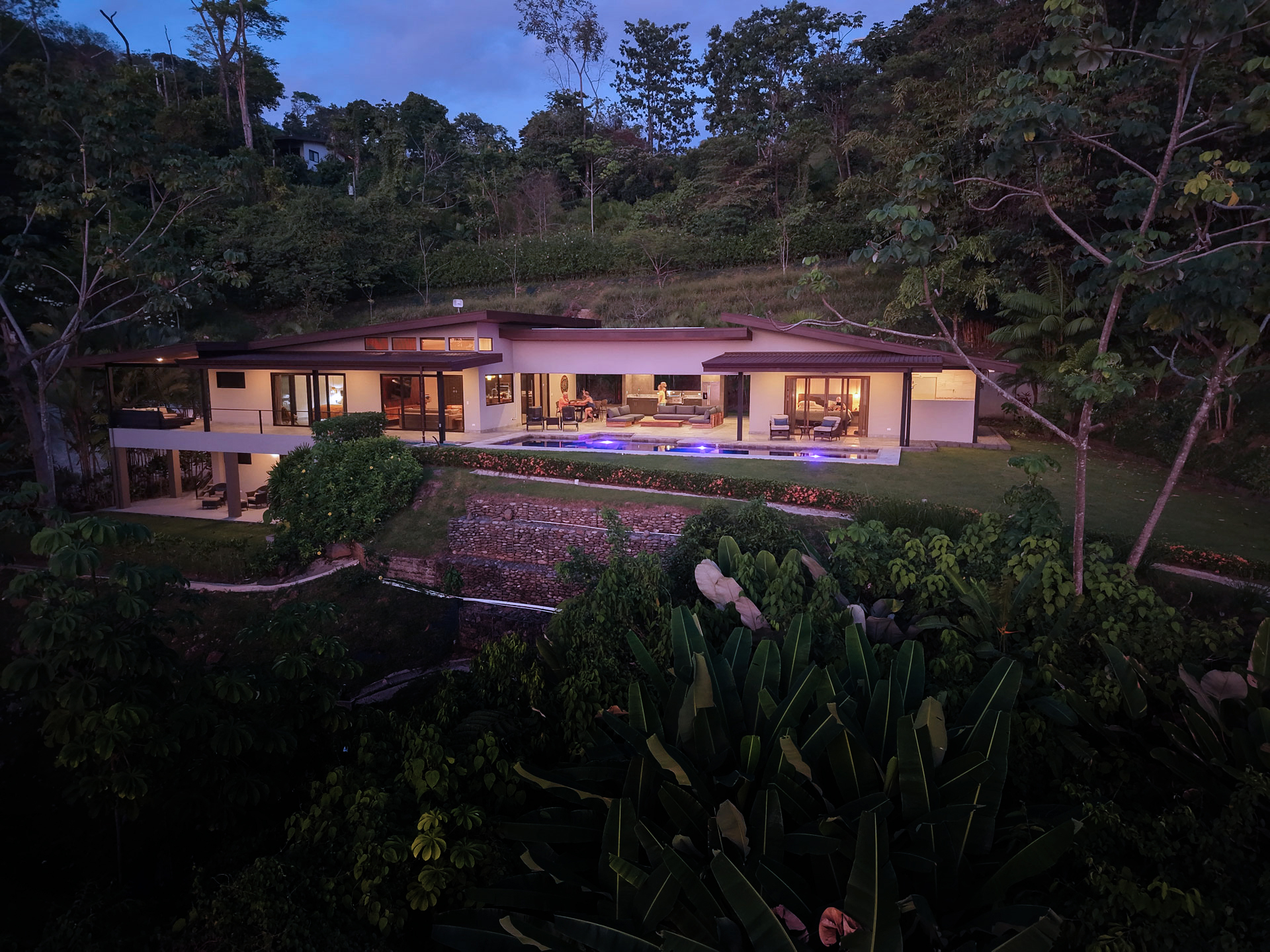 Villa Ballena lit up at dusk in the rainforest